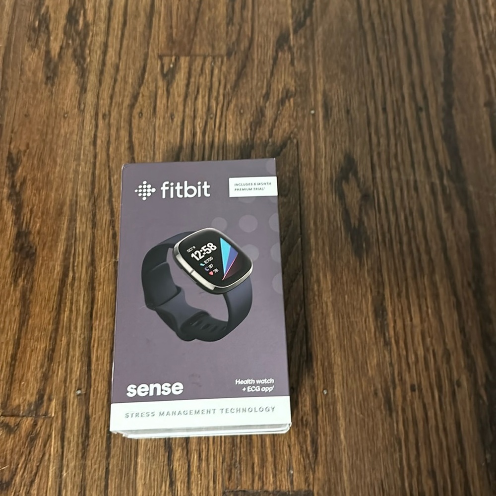 Fitbit sense with orange sports band. With box and charger.